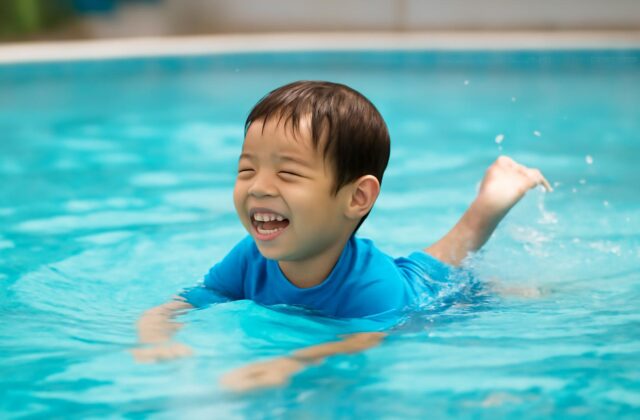 child swimming happy