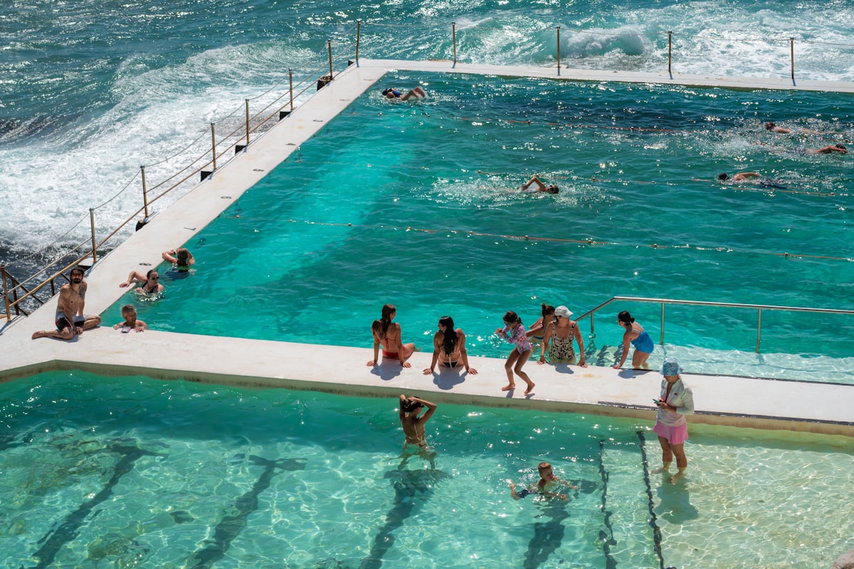People swim in an outdoor ocean pool