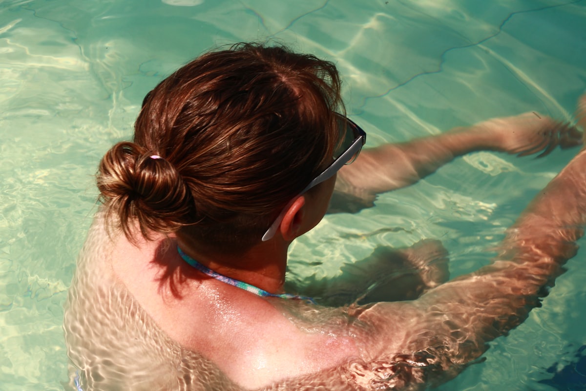 a woman swimming in a pool of water